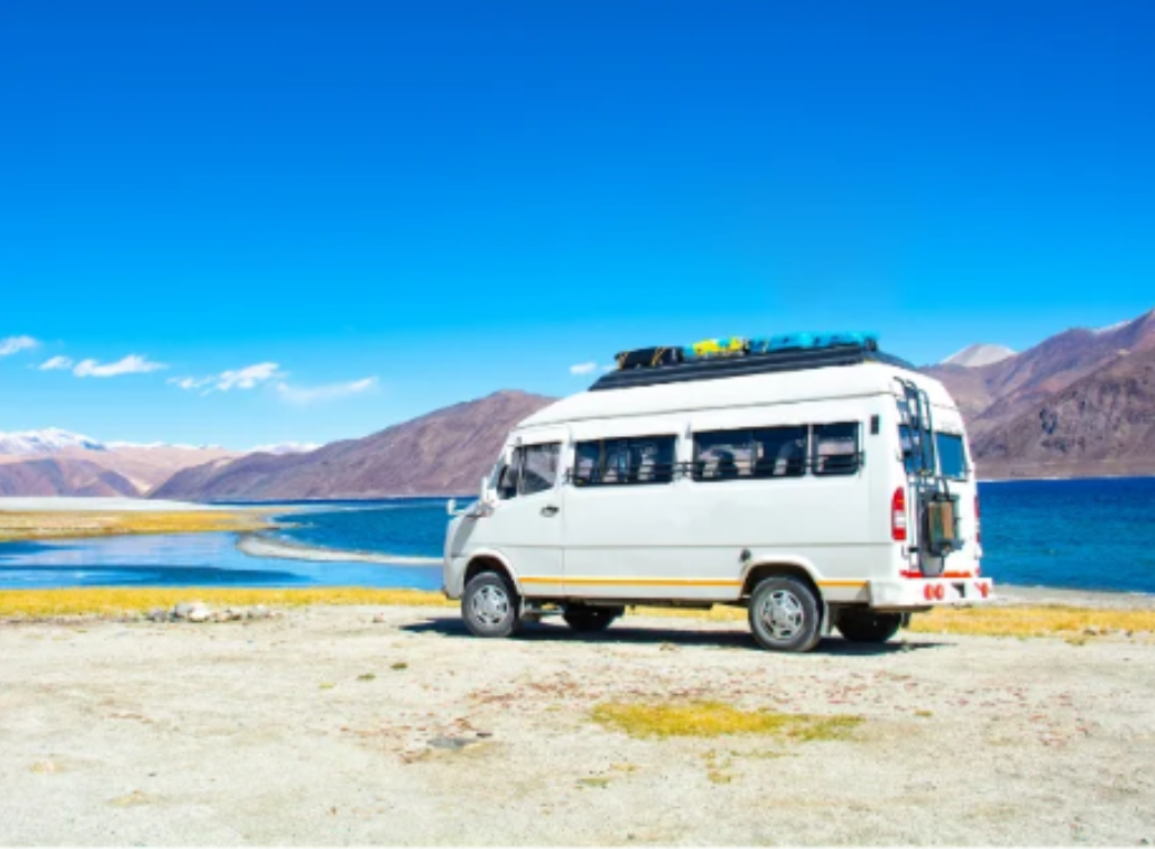 Mini bus traveling through a scenic mountain road