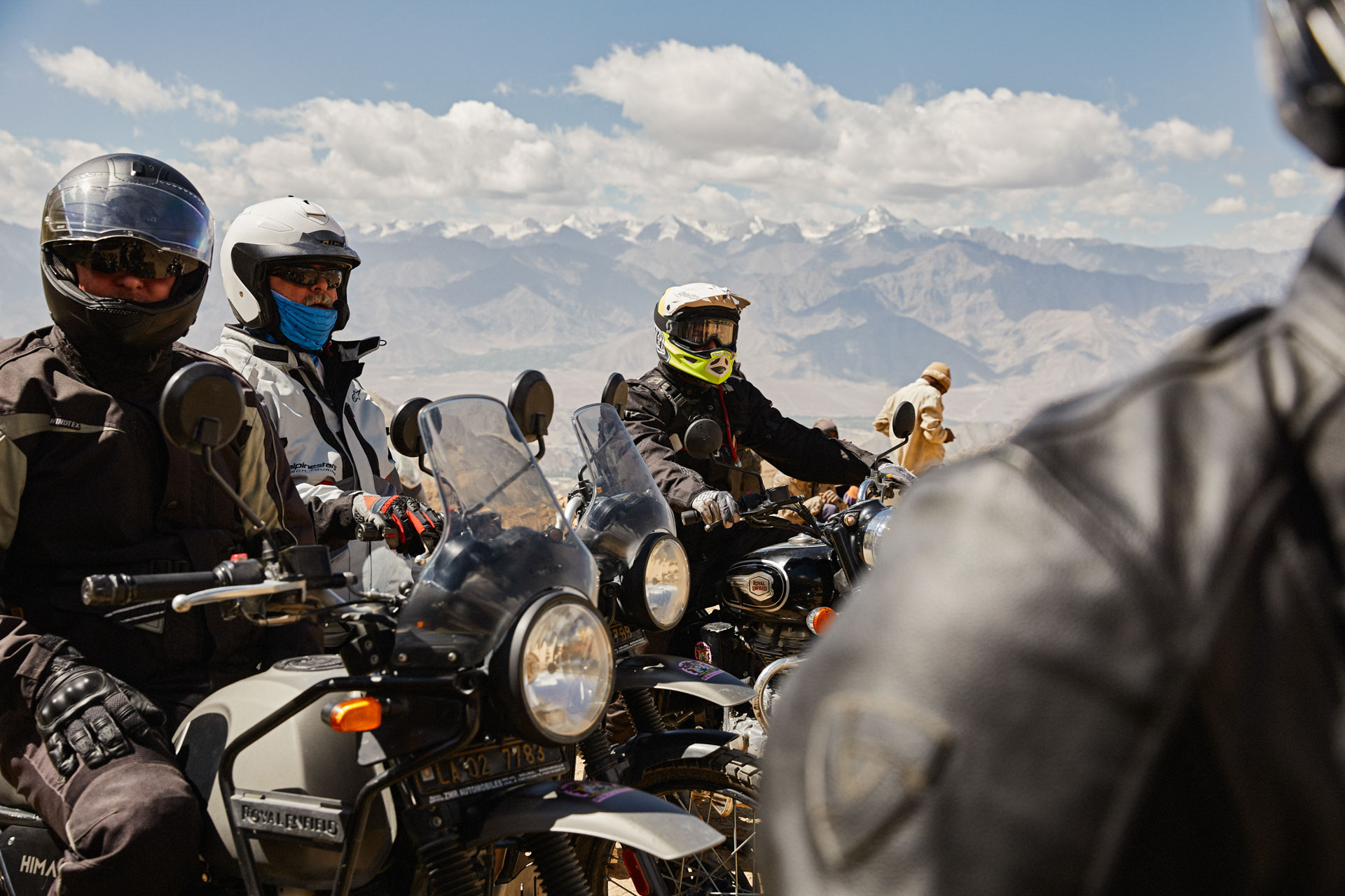 Small group of motorcyclists together in the mountains